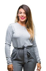Young beautiful worker business woman over isolated background winking looking at the camera with...
