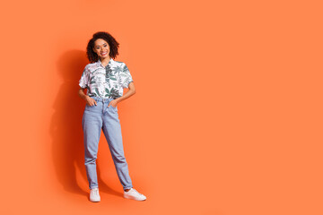 Photo portrait of attractive model girl in jeans and stylish hawaiian trendy shirt posing at black friday season sale isolated on orange color background