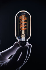Retro light bulb on black background.