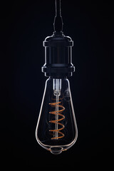 Retro light bulb on black background.