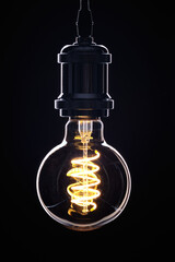 Retro light bulb on black background.