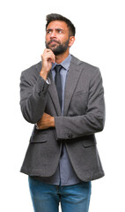 Fototapeta premium Adult hispanic business man over isolated background with hand on chin thinking about question, pensive expression. Smiling with thoughtful face. Doubt concept.
