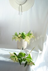 white hat and flowerson a white background 