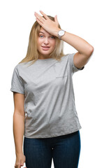 Fototapeta premium Young caucasian woman over isolated background surprised with hand on head for mistake, remember error. Forgot, bad memory concept.