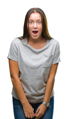 Fototapeta premium Young caucasian beautiful woman over isolated background afraid and shocked with surprise expression, fear and excited face.