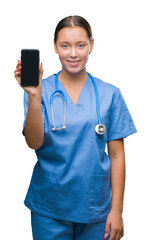 Young caucasian doctor woman showing smarpthone over isolated background with a happy face standing and smiling with a confident smile showing teeth