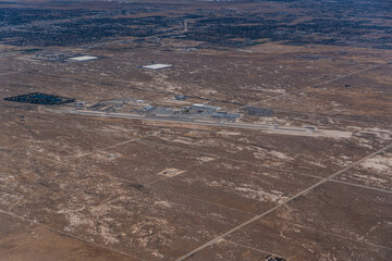 aerial view of landscape around General William J. Fox Airfield with runway system, terminal and apron in Lancaster, California 
