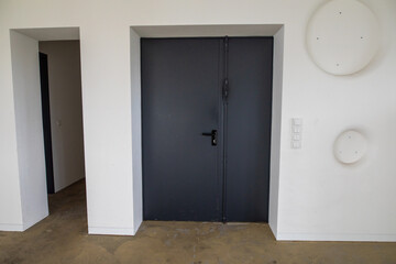 Modern Interior with Black Door and White Walls