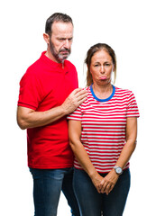 Fototapeta premium Middle age hispanic couple in love over isolated background depressed and worry for distress, crying angry and afraid. Sad expression.