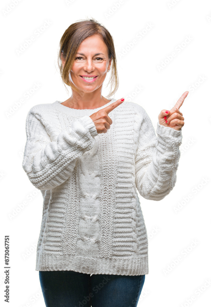 Wall mural middle age senior hispanic woman wearing winter sweater over isolated background smiling and looking