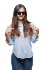 Young asian woman wearing sunglasses over isolated background looking confident with smile on face, pointing oneself with fingers proud and happy.