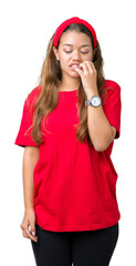 Young beautiful brunette woman wearing red t-shirt over isolated background looking stressed and nervous with hands on mouth biting nails. Anxiety problem.