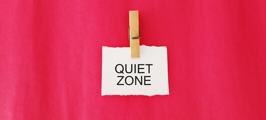 The words quiet zone on the beach sand background.
