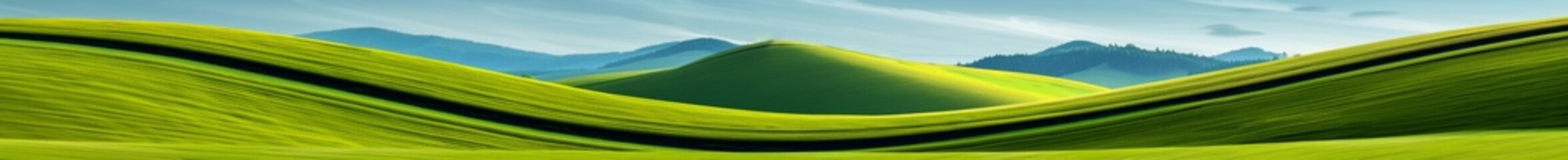 Obraz premium abstract green rolling hills landscape with sky and trees in the distance - nature photography.