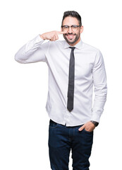 Young handsome business man wearing glasses over isolated background Pointing with hand finger to face and nose, smiling cheerful