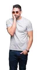 Young handsome man wearing sunglasses over isolated background thinking looking tired and bored...