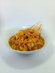 Sate Padang: Specialty Satay from Minangkabau Cuisine, Padang, Indonesia. Authentic Grilled Skewers Highlighting Rich Spices and Flavors, Presented on a White Background