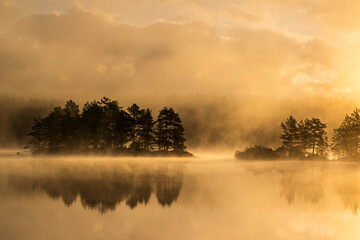 Scenic view of lake against sky at sunset