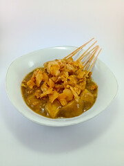 Sate Padang: Specialty Satay from Minangkabau Cuisine, Padang, Indonesia. Authentic Grilled Skewers Highlighting Rich Spices and Flavors, Presented on a White Background