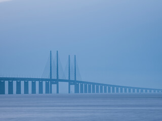 Oeresund bridge over sea against sky during foggy weather
