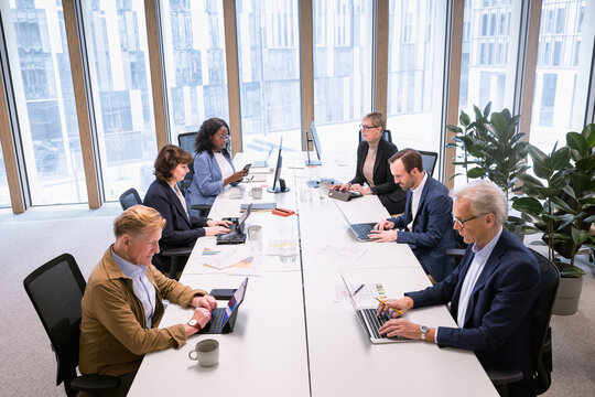 Multiracial corporate colleagues working in office
