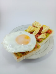 Mashed Avocado, Diced Tomato, Omelette, Sunny Side Up on Toast: Flavorful and Colorful Breakfast Combination Featuring Fresh Ingredients, Perfectly Presented on a Clean White Background