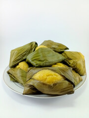 Beppa Oto: A Traditional Bugis Dessert from Sulawesi, Indonesia. Made of Banana and Wrapped in Banana Leaf, Presented on a White Background, Highlighting Rich Cultural Heritage and Culinary Tradition