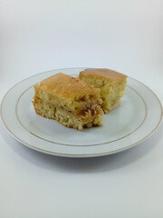 Martabak Manis: A Popular Indonesian Sweet Treat. This Thick, Sweet, and Chewy Pancake with a Honeycomb Texture is Soaked in Butter, Presented on a White Background, Showcasing Its Deliciousness