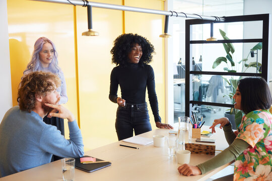 Multiracial coworkers discussing ideas in office
