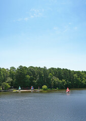 People sailing and kayaking on the Bond Park lake in Cary North Carolina