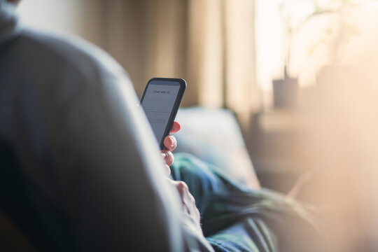 Man taking assistance of AI through smart phone at home