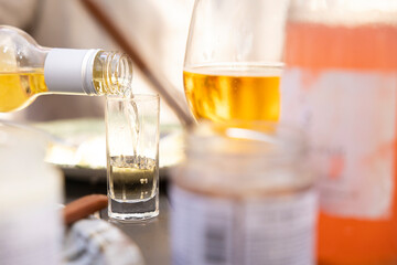 Beer being poured in shot glass