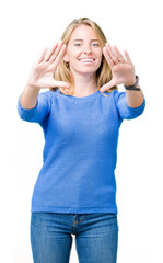 Beautiful young woman wearing blue sweater over isolated background Smiling doing frame using hands palms and fingers, camera perspective