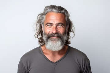 Obraz premium Smiling bearded mature man portrait against white background