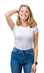 Obraz premium Beautiful young woman wearing casual white t-shirt over isolated background Smiling confident touching hair with hand up gesture, posing attractive