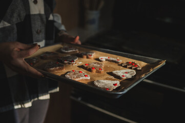 Baking tray of gingerbread cookies being held
