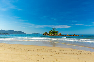 Small rocky islet on Bonete beach in Ilhabela on the coast of Sao Paulo