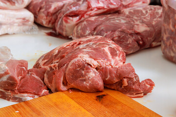 Raw pork meat is prepared for marinating before grilling on BBQ