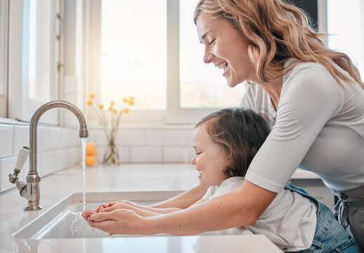 Mother, girl and washing hands in kitchen for hygiene, cleaning and water to protect against germs. Mommy, daughter and liquid for skincare or prevention of bacteria, virus and remove dirt at home