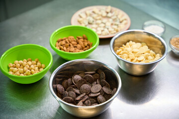 Many ingredients in bowls standing on professional kitchen table