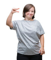 Fototapeta premium Young adult woman with down syndrome over isolated background smiling and confident gesturing with hand doing size sign with fingers while looking and the camera. Measure concept.