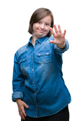 Young adult woman with down syndrome over isolated background doing stop sing with palm of the...