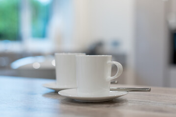 white cup of coffee with saucer