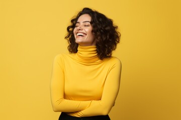 Fototapeta premium Portrait of a joyful woman in her 30s wearing a classic turtleneck sweater while standing against soft yellow background