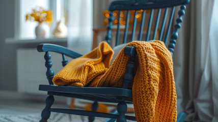 Rocking chair with a cozy yellow knit blanket in a sunlit room.