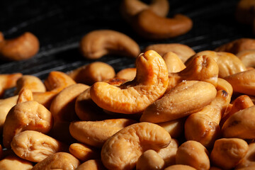 cashew nuts on black wood background