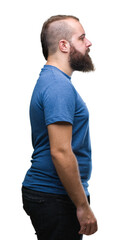 Young caucasian hipster man over isolated background looking to side, relax profile pose with natural face with confident smile.