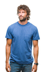 Fototapeta premium Handsome hispanic model man over isolated background looking away to side with smile on face, natural expression. Laughing confident.