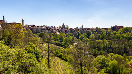 Obraz premium Panoramablick über die bunte und historische mittelalterliche Stadt Rothenburg ob der Tauber. Mit den bunten Fachwerkfassaden und den vielen berühmten Türmen und der Stadtmauer