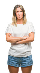 Fototapeta premium Young beautiful woman over isolated background skeptic and nervous, disapproving expression on face with crossed arms. Negative person.
